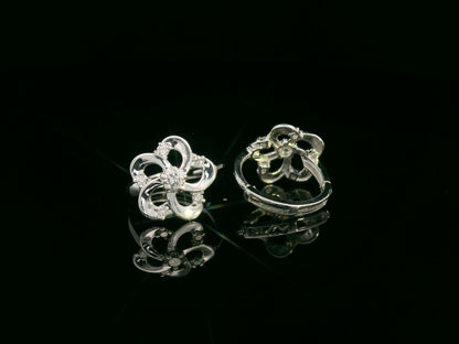 White gold earrings shaped like a flower with diamond accents