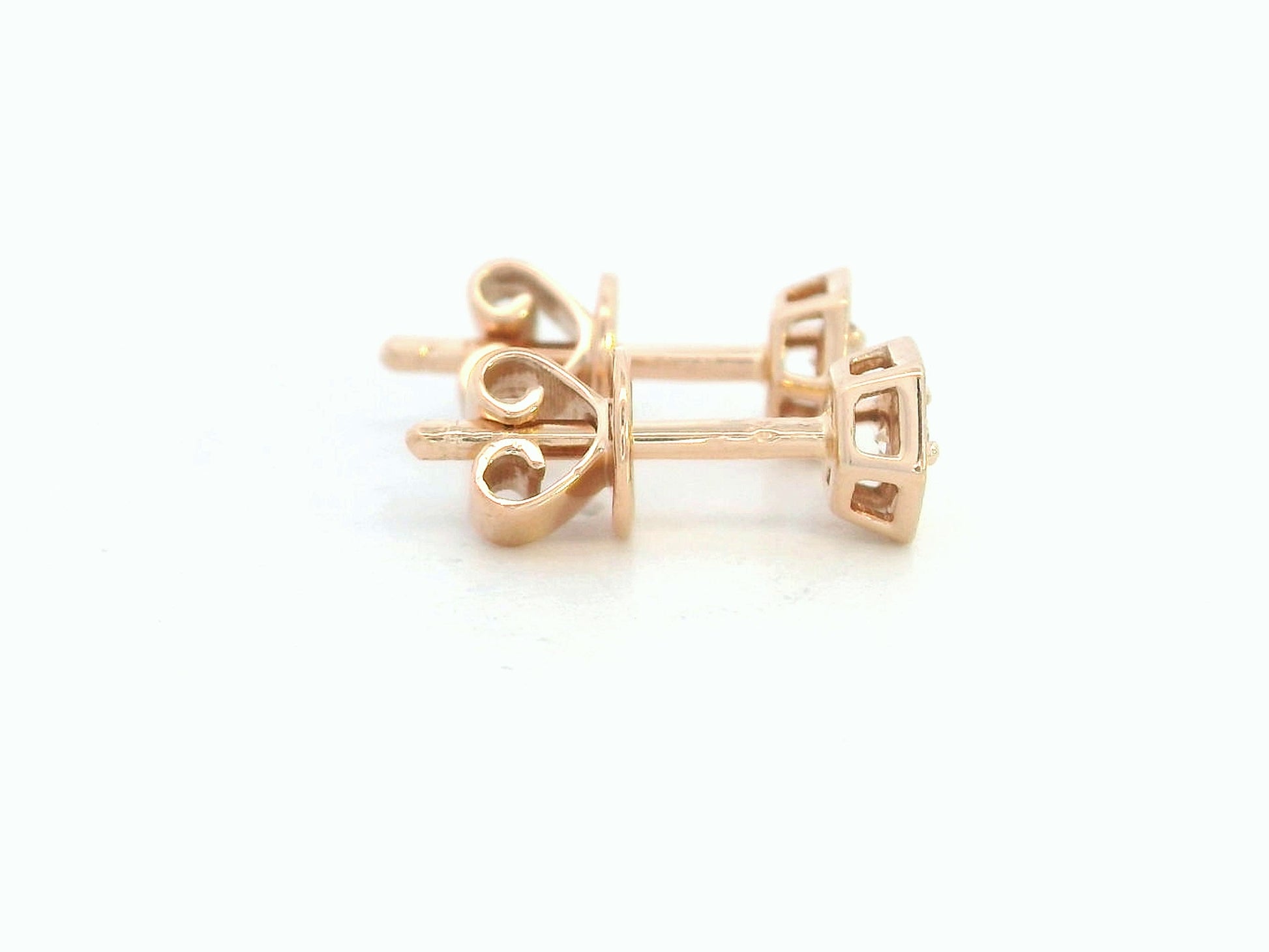 Side profile of 18k rose gold hexagon stud earrings showing push back closure