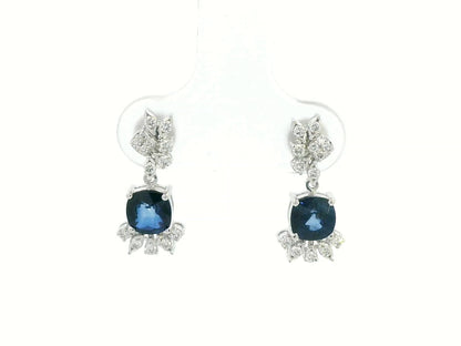 Front view of 18k white gold drop earrings with cushion-cut blue sapphires and diamonds