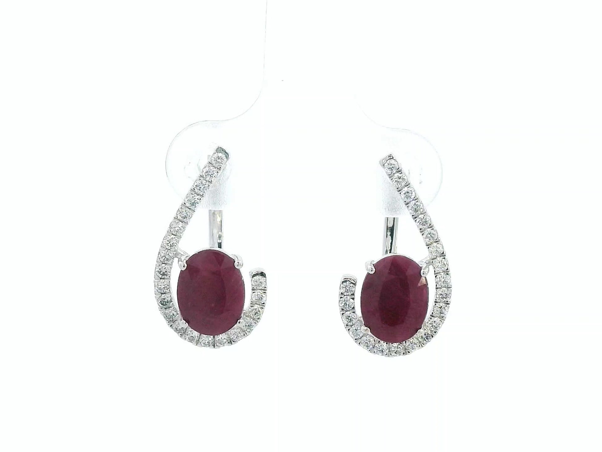 Front view of 18k white gold earrings with oval rubies totaling 2.96 carats and 0.38 carat pave diamonds, latch-back closure