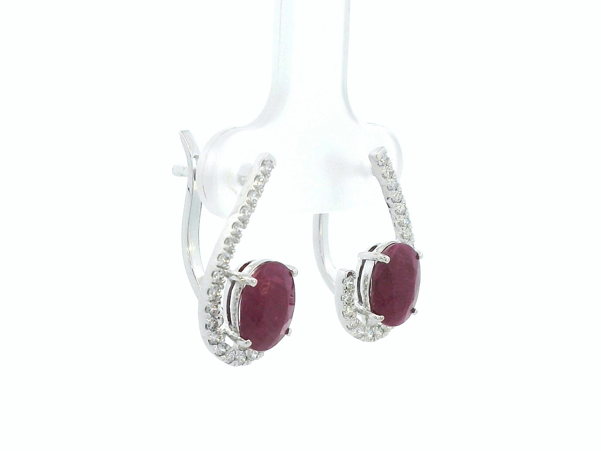 Side profile of 18k white gold ruby and diamond pave curve earrings, showing depth and curved design