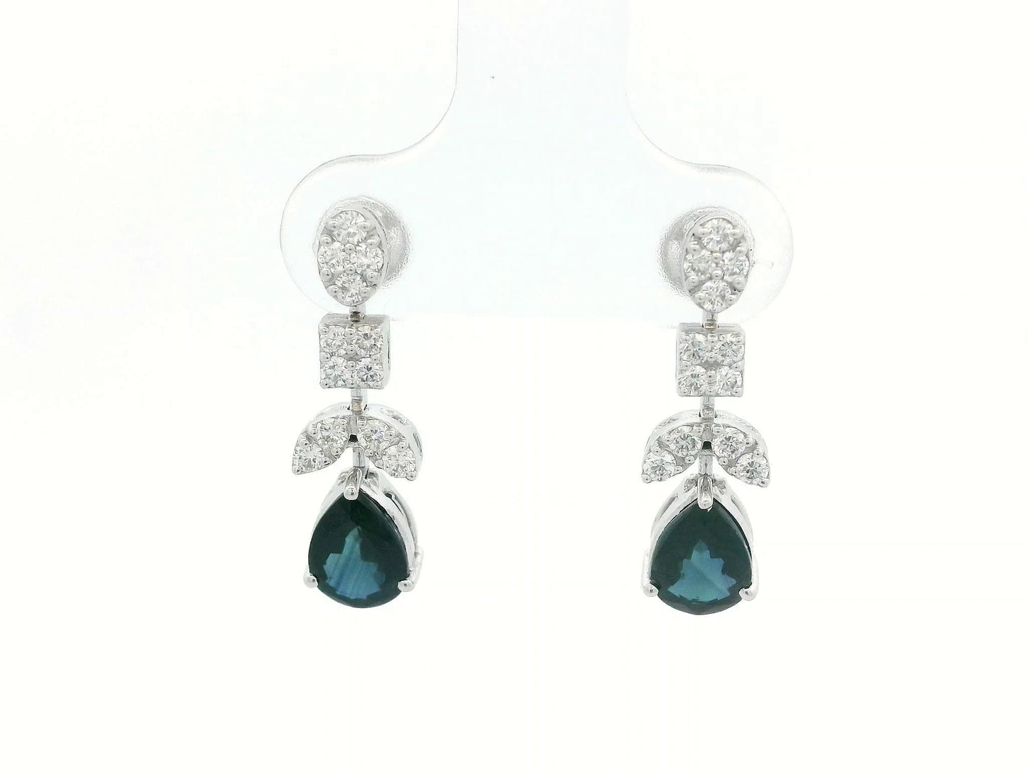Front view of 18k gold drop earrings with pear-cut blue sapphires and diamond clusters in mixed-shape design