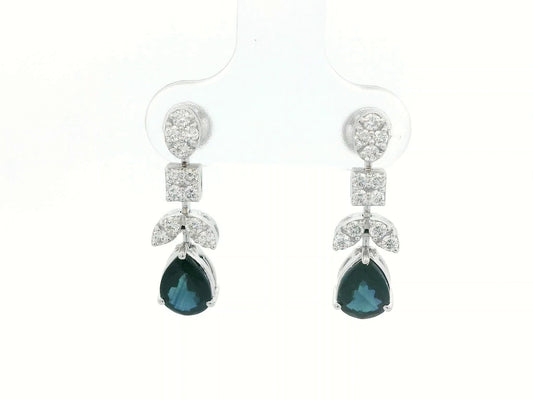 Front view of 18k gold drop earrings with pear-cut blue sapphires and diamond clusters in mixed-shape design