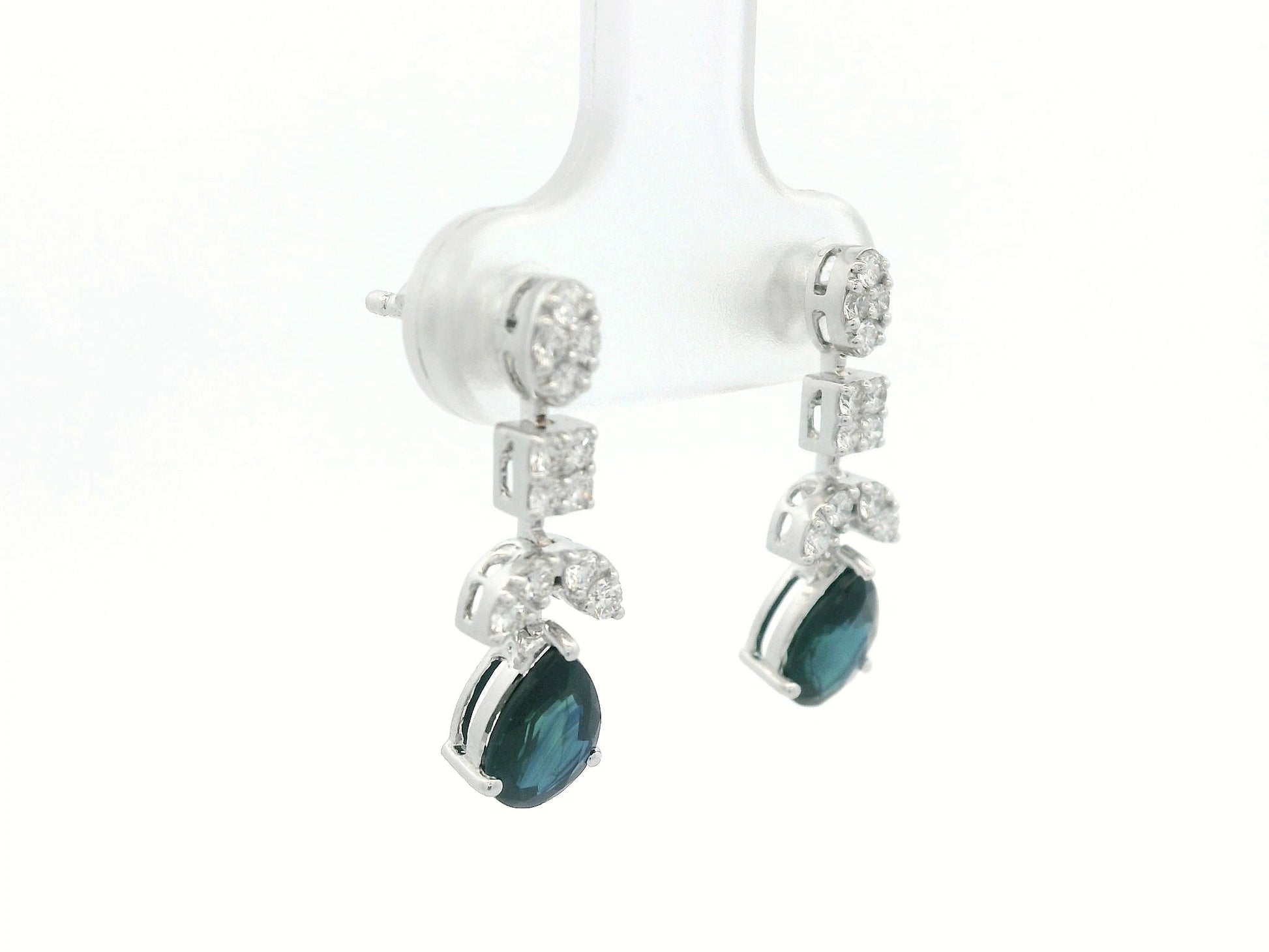 Side profile of 18k gold sapphire and diamond drop earrings showing mixed-shape cluster leading to pear-cut sapphire
