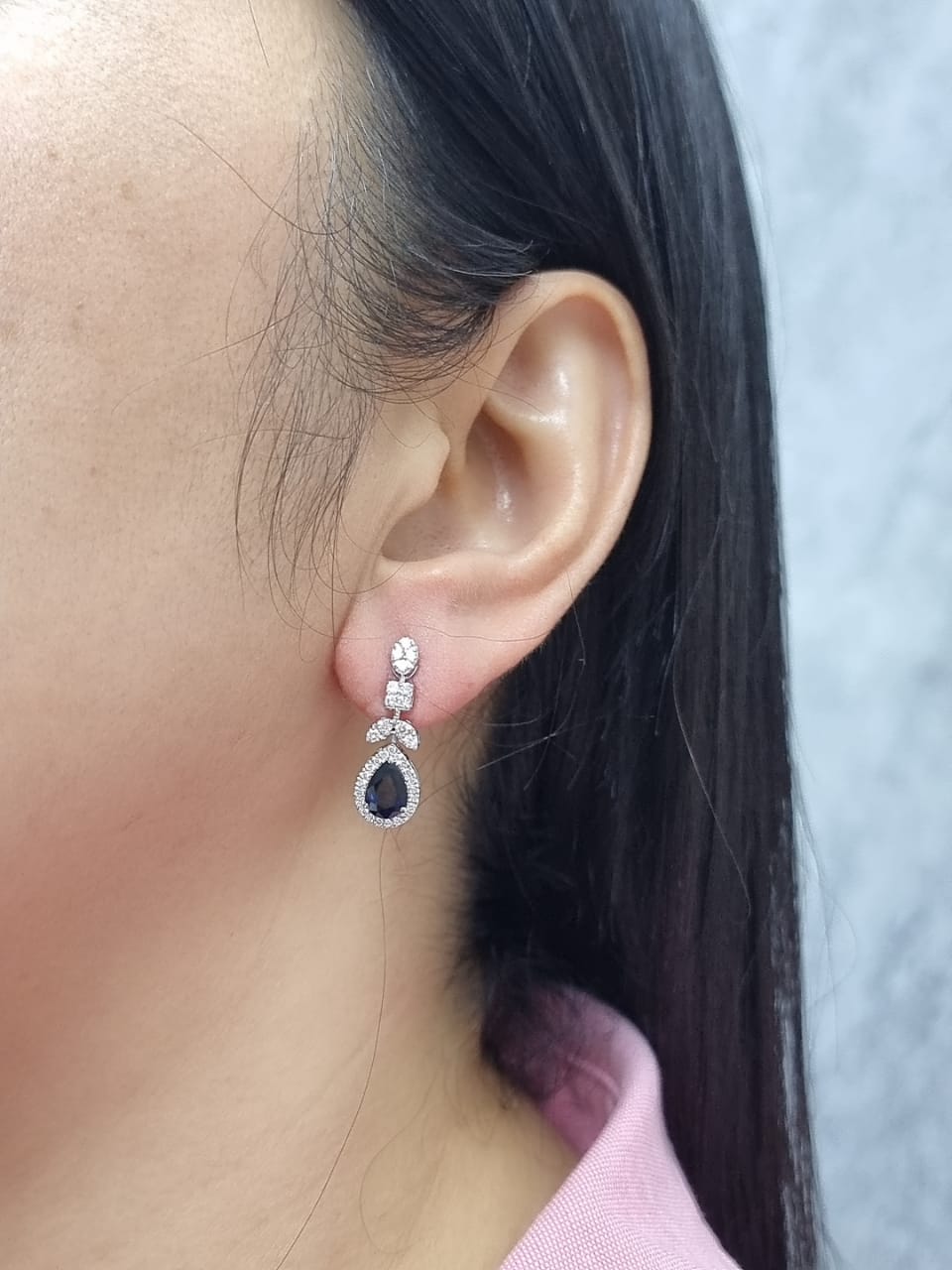 18k white gold dangle earrings with pear-cut blue sapphires totaling 1.85 carat and 0.55 carat diamonds in halo and filigree design