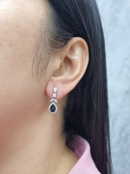 18k white gold dangle earrings with pear-cut blue sapphires totaling 1.85 carat and 0.55 carat diamonds in halo and filigree design