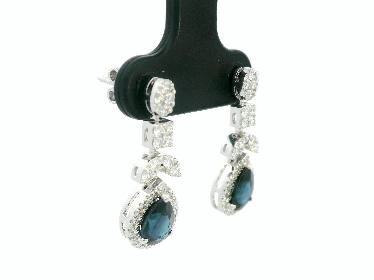 18k white gold dangle earrings with pear-cut blue sapphires totaling 1.85 carat and 0.55 carat diamonds in halo and filigree design