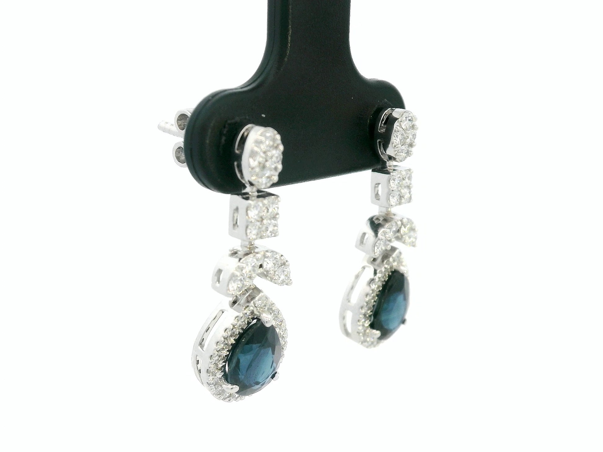 18k white gold dangle earrings with pear-cut blue sapphires totaling 1.85 carat and 0.55 carat diamonds in halo and filigree design