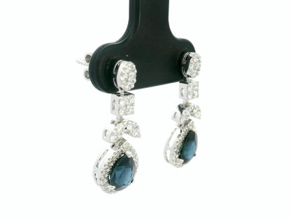 18k white gold dangle earrings with pear-cut blue sapphires totaling 1.85 carat and 0.55 carat diamonds in halo and filigree design