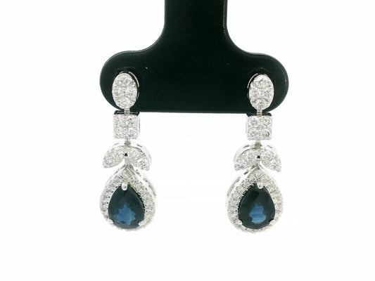 18k white gold dangle earrings with pear-cut blue sapphires totaling 1.85 carat and 0.55 carat diamonds in halo and filigree design