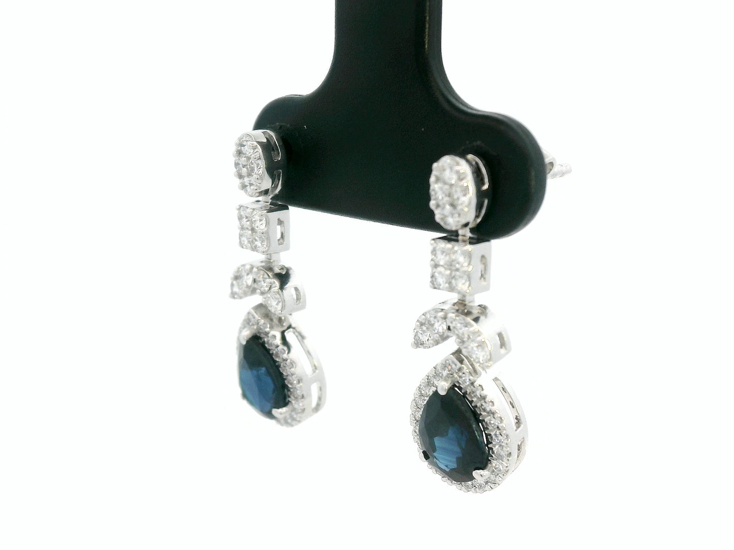 18k white gold dangle earrings with pear-cut blue sapphires totaling 1.85 carat and 0.55 carat diamonds in halo and filigree design