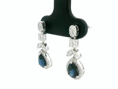 18k white gold dangle earrings with pear-cut blue sapphires totaling 1.85 carat and 0.55 carat diamonds in halo and filigree design