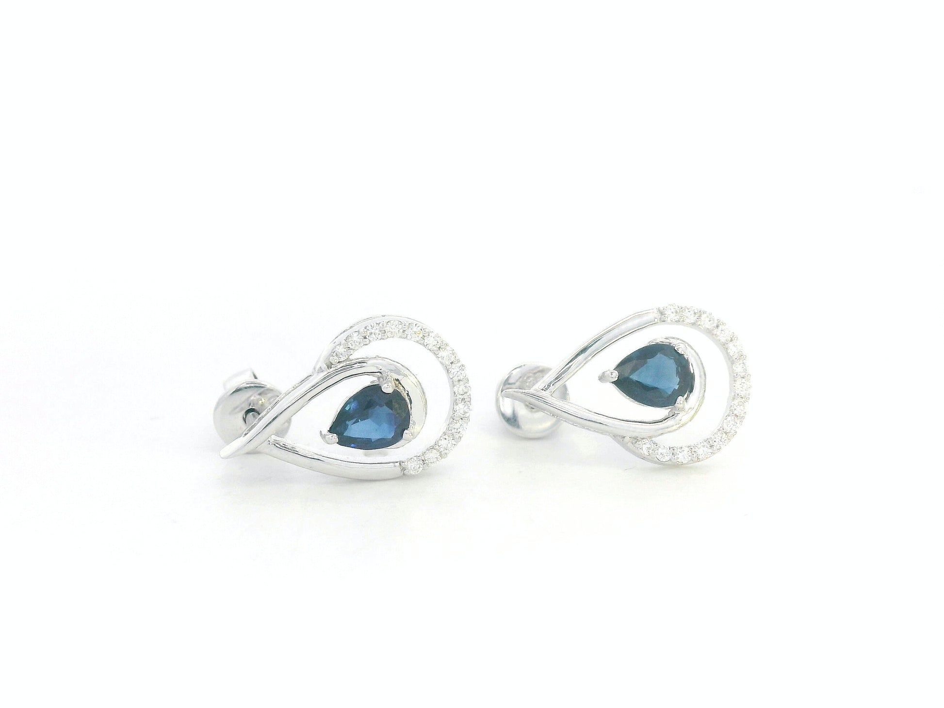 18k white gold teardrop earrings with pear-cut blue sapphires totaling 0.73 carat and 0.15 carat diamonds in partial halo