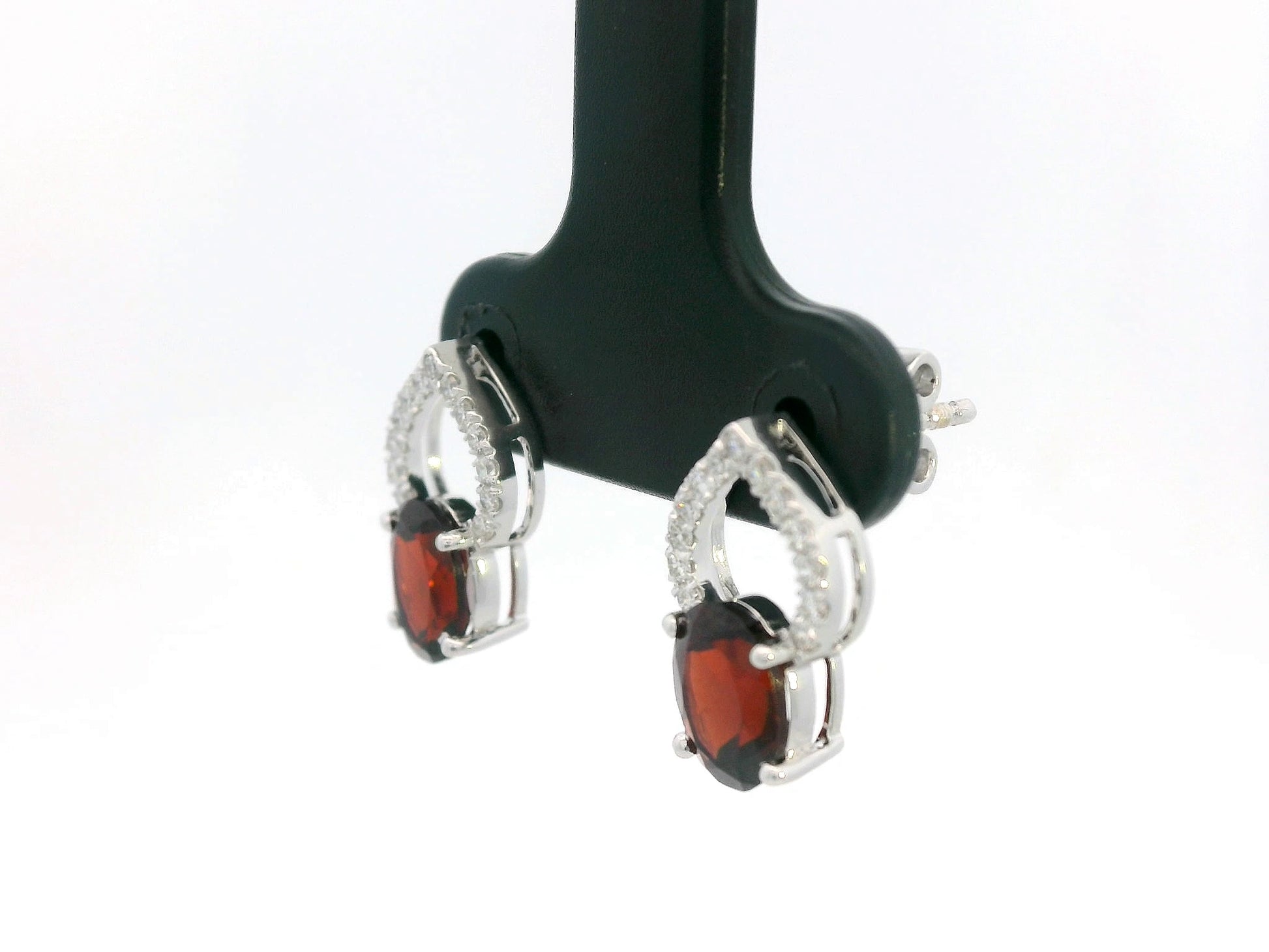 18k white gold stud earrings with oval garnets totaling 1.92 carat and 0.18 carat diamonds in open teardrop design
