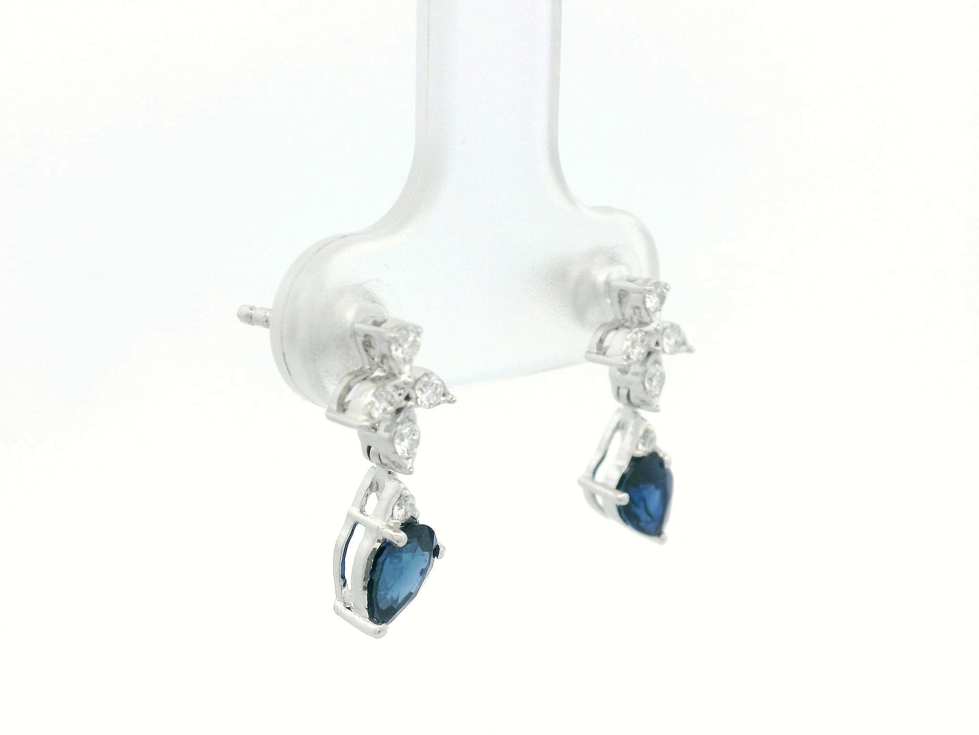 18k white gold floral stud earrings with 0.79 carat pear-cut blue sapphires dangling from 0.16 carat diamond clusters