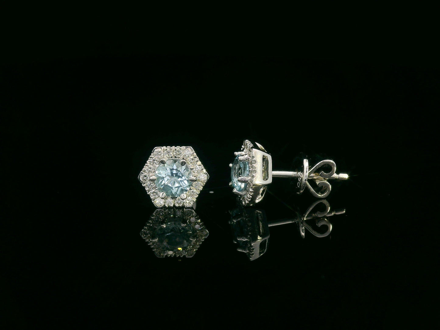 Front view of 18k gold stud earrings with round aquamarines and diamond halo