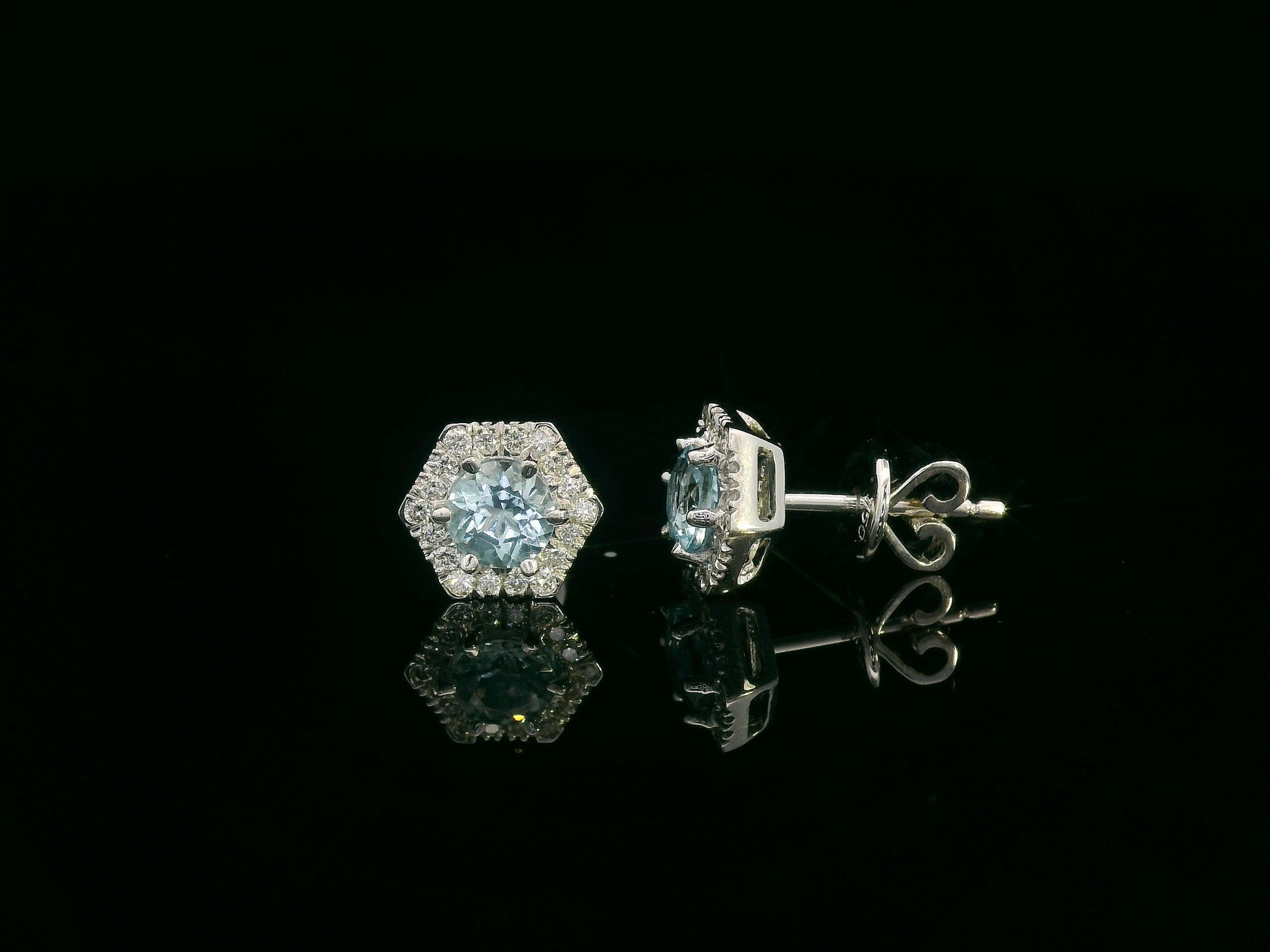 Front view of 18k gold stud earrings with round aquamarines and diamond halo