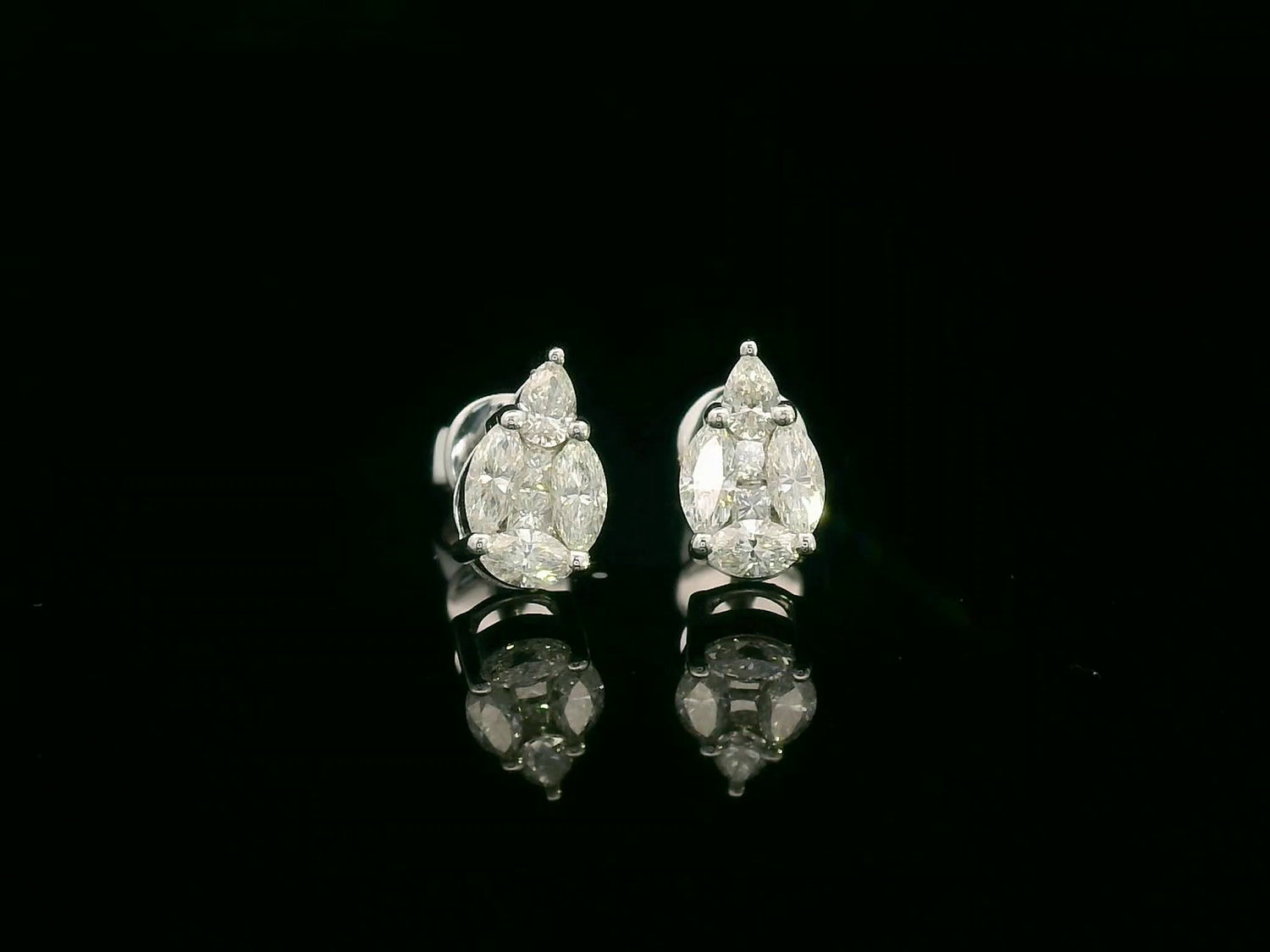 Front view of 18k white gold stud earrings with pear, marquise, and princess-cut diamond cluster