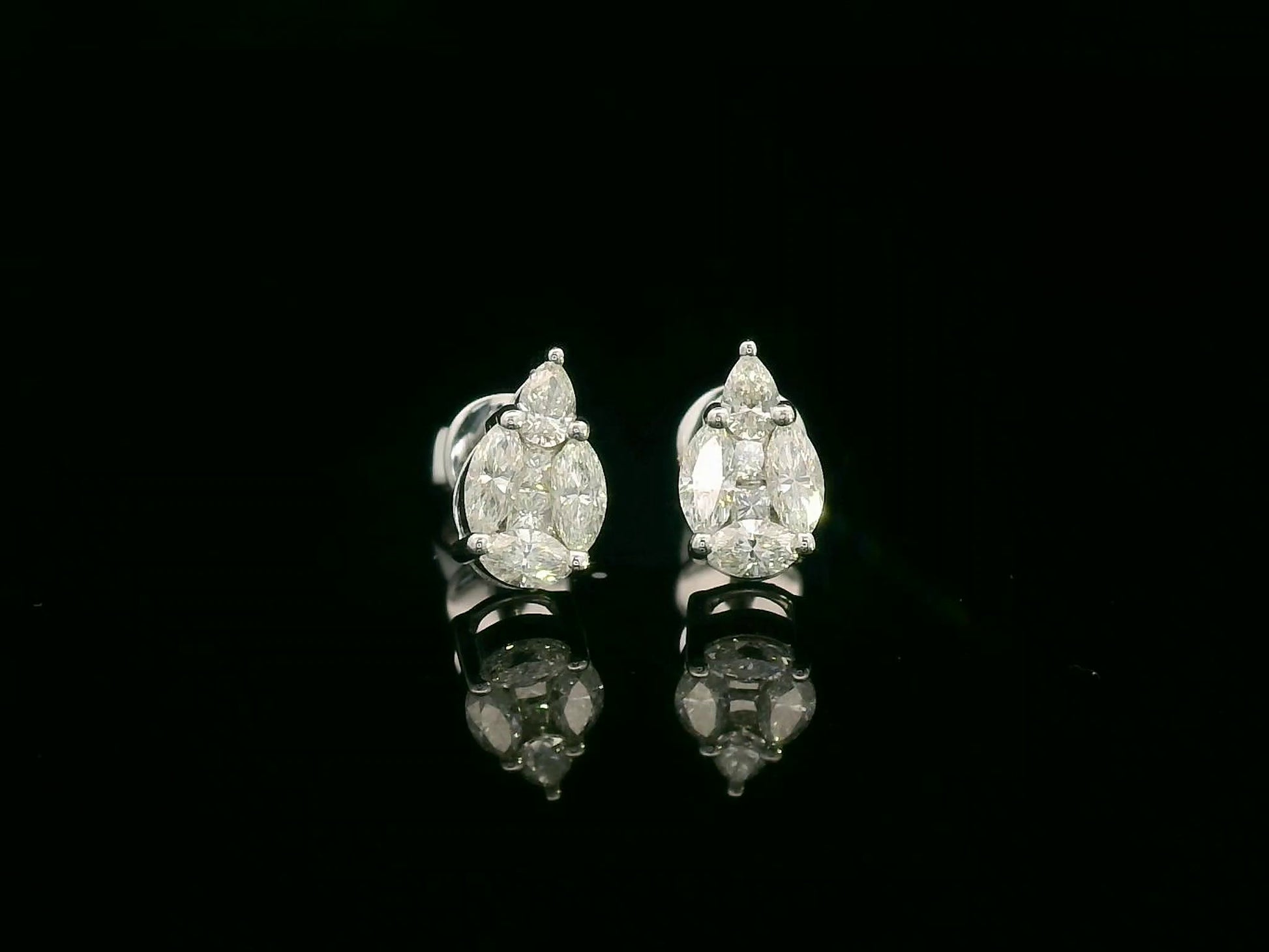 Front view of 18k white gold stud earrings with pear, marquise, and princess-cut diamond cluster