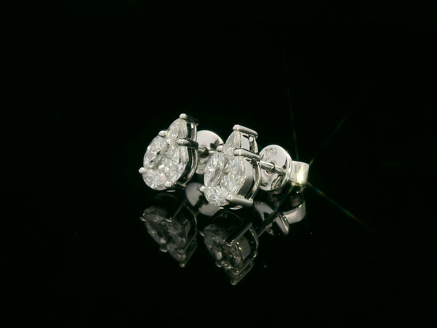 side view of 18k white gold stud earrings with pear, marquise, and princess-cut diamond cluster