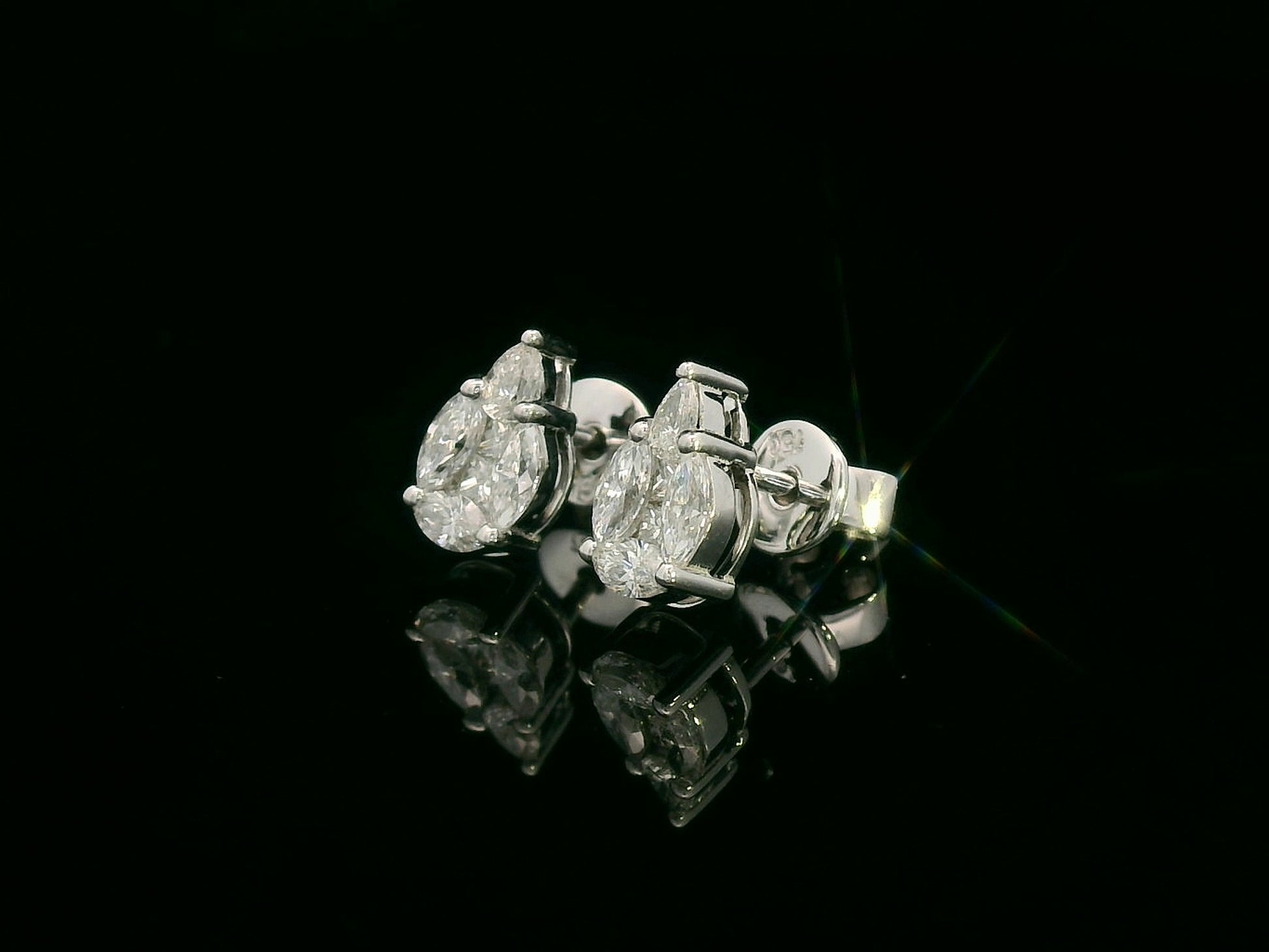 side view of 18k white gold stud earrings with pear, marquise, and princess-cut diamond cluster