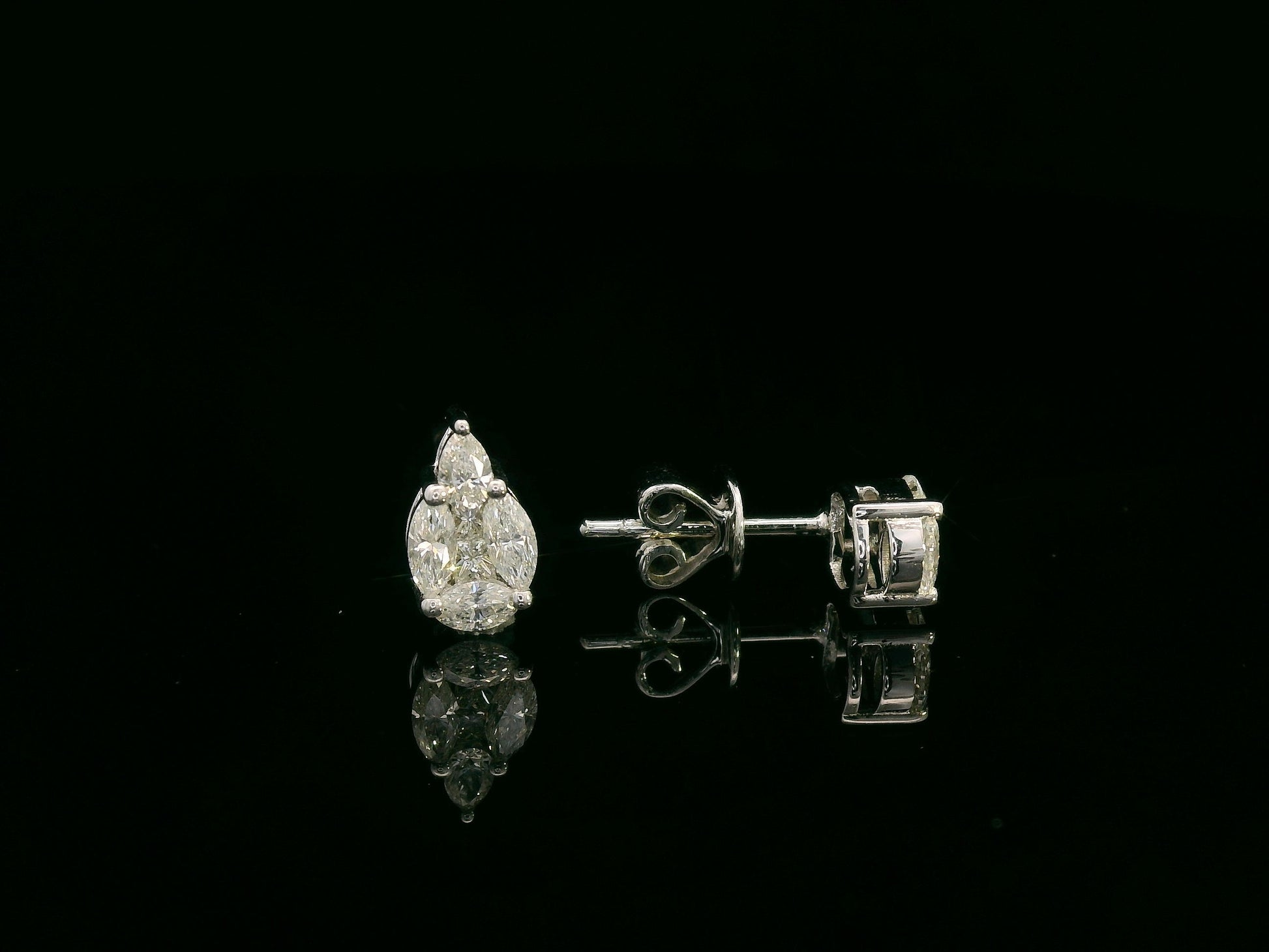 Front view of 18k white gold stud earrings with pear, marquise, and princess-cut diamond cluster