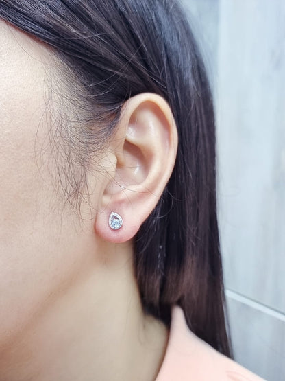 18K white gold earrings featuring 0.49ct round-cut aquamarine with 0.08ct diamond teardrop accent on one side of each stone.