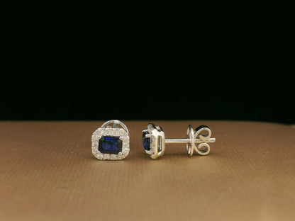 Minimalist 18K white gold halo stud earrings with emerald-cut blue sapphires and diamond accents 