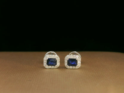 Minimalist 18K white gold halo stud earrings with emerald-cut blue sapphires and diamond accents 