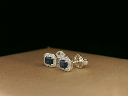 Minimalist 18K white gold halo stud earrings with emerald-cut blue sapphires and diamond accents 
