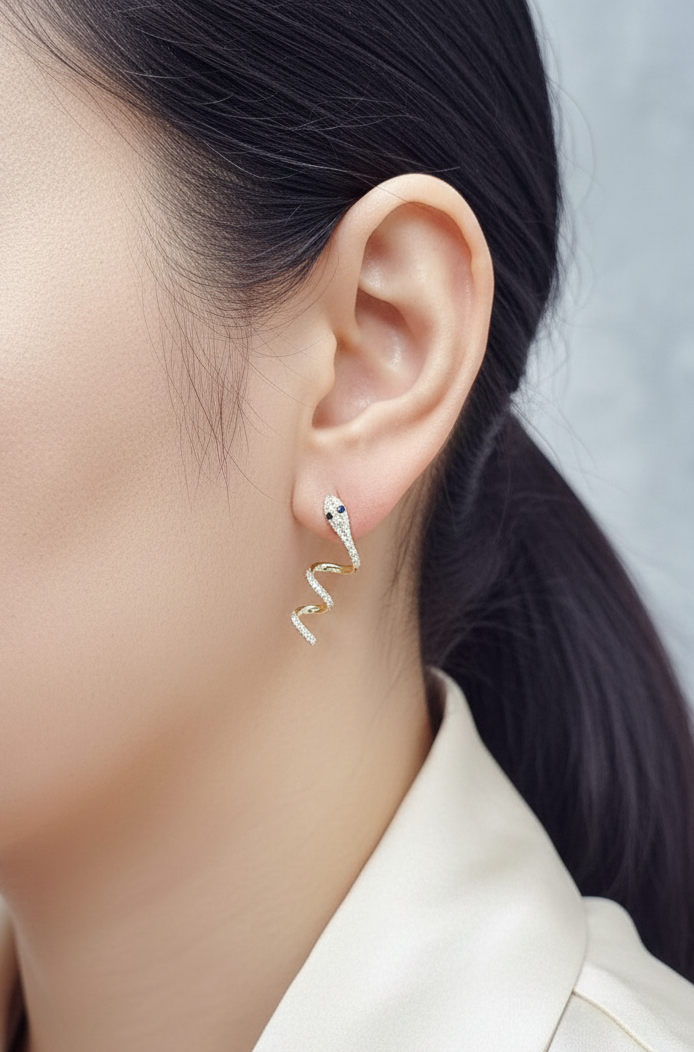 18K yellow gold diamond snake drop earrings with blue sapphire eyes, 0.43 carat diamonds by Emirates Diamonds