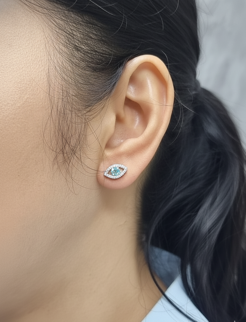 18K white gold evil-eye stud earrings with 0.40ct aquamarine center and 0.23ct pavé diamond halo
