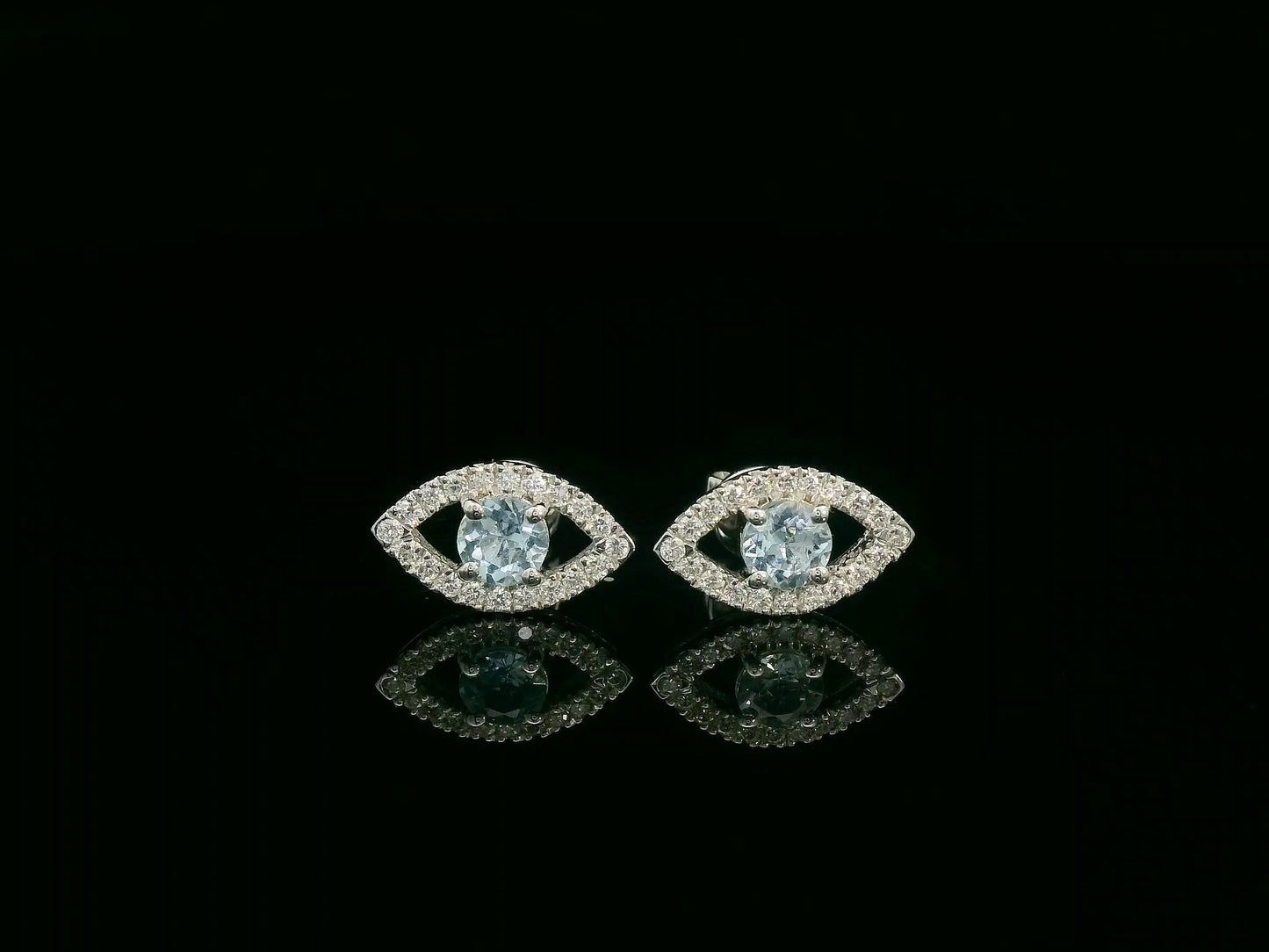 18K white gold evil-eye stud earrings with 0.40ct aquamarine center and 0.23ct pavé diamond halo