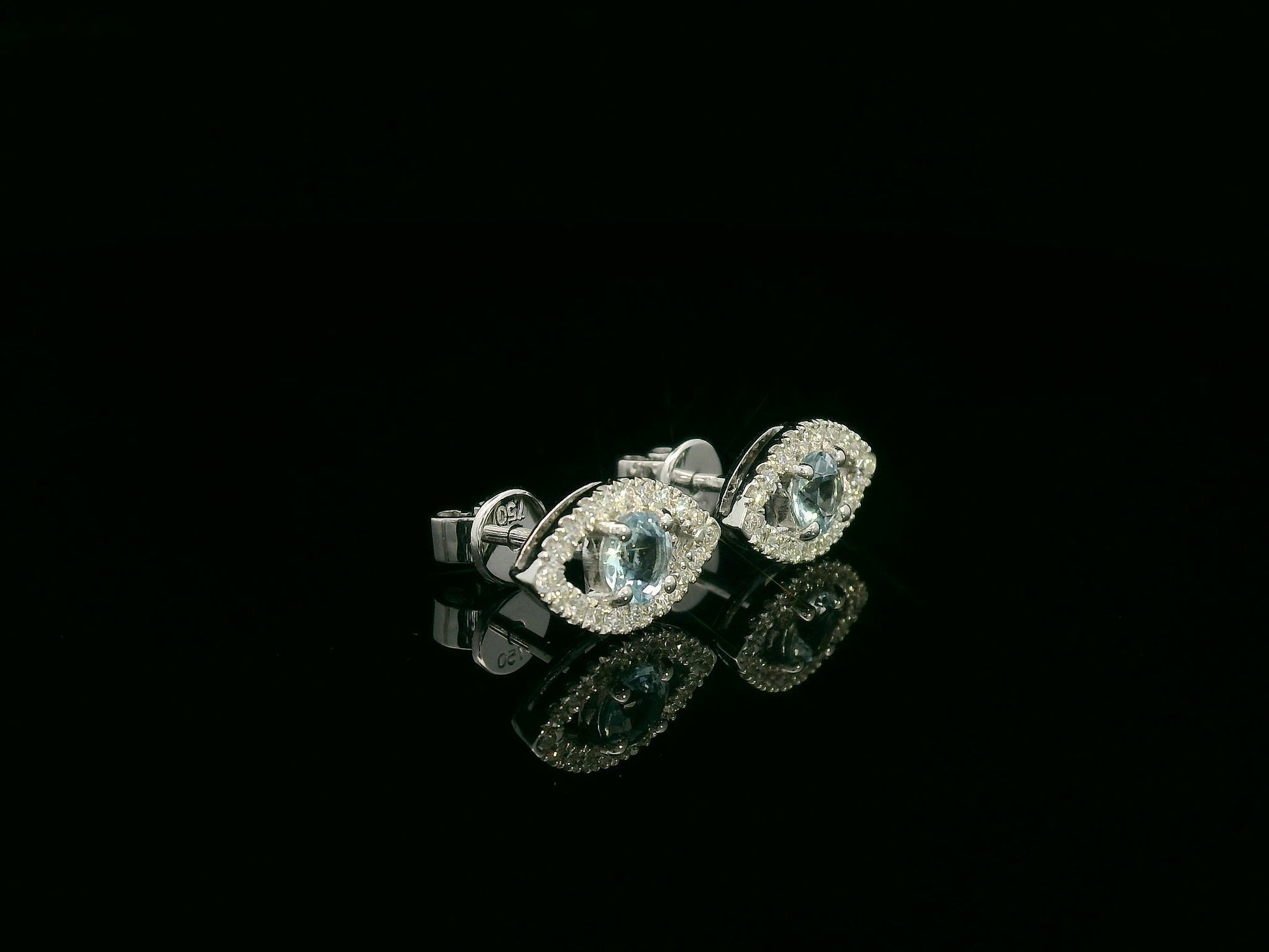 18K white gold evil-eye stud earrings with 0.40ct aquamarine center and 0.23ct pavé diamond halo