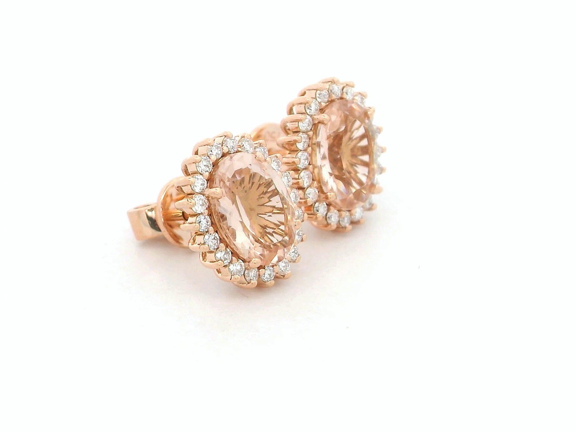 18K rose gold morganite and diamond halo stud earrings – oval morganite studs with pavé diamond halo by Emirates Diamonds.