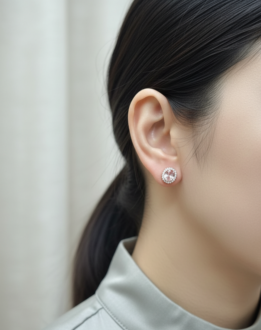 18K rose gold morganite and diamond halo stud earrings – oval morganite studs with pavé diamond halo by Emirates Diamonds.