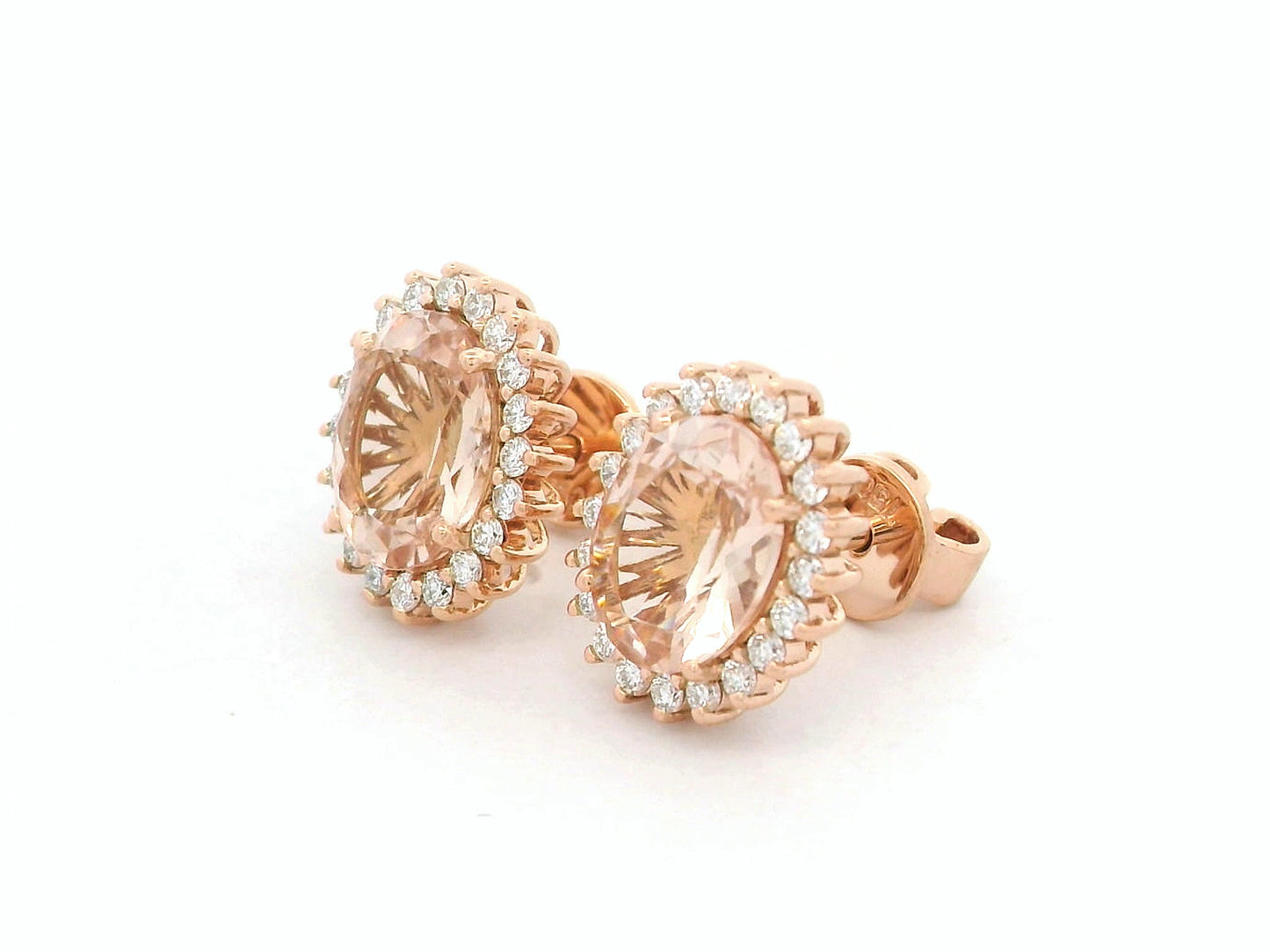 18K rose gold morganite and diamond halo stud earrings – oval morganite studs with pavé diamond halo by Emirates Diamonds.