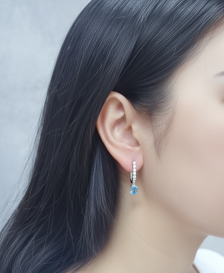 18K white gold dangle earrings with 2.32 ct emerald-cut blue topaz and 0.58 ct round diamonds