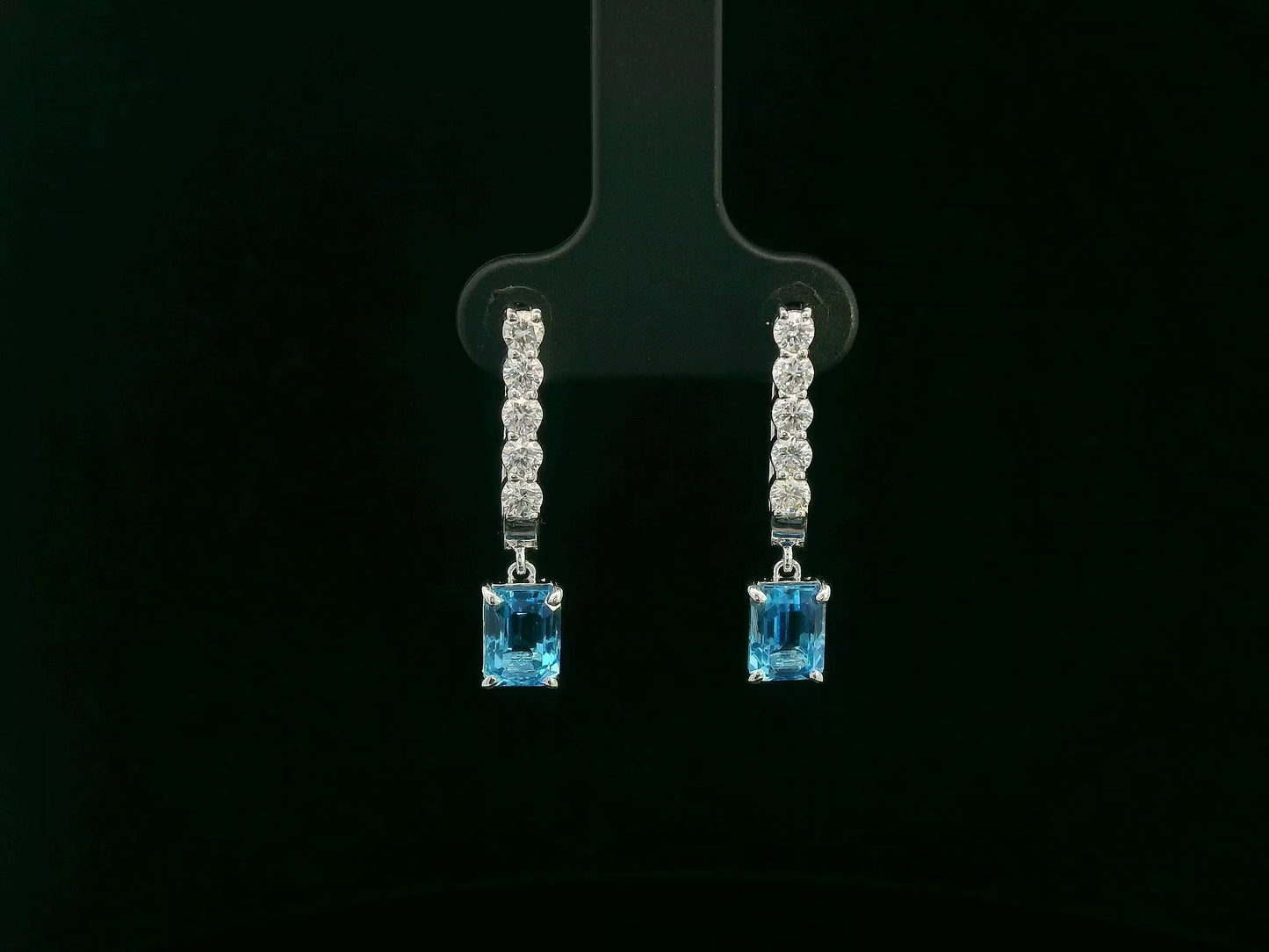 18K white gold dangle earrings with 2.32 ct emerald-cut blue topaz and 0.58 ct round diamonds