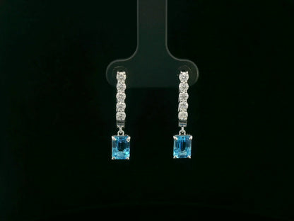 18K white gold dangle earrings with 2.32 ct emerald-cut blue topaz and 0.58 ct round diamonds