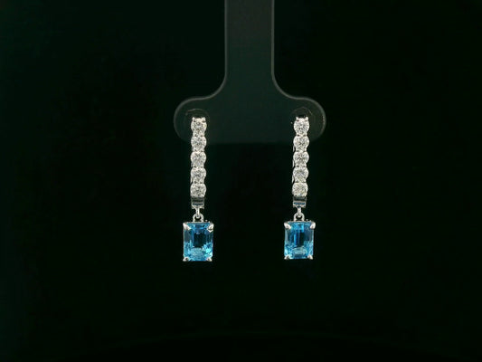 18K white gold dangle earrings with 2.32 ct emerald-cut blue topaz and 0.58 ct round diamonds