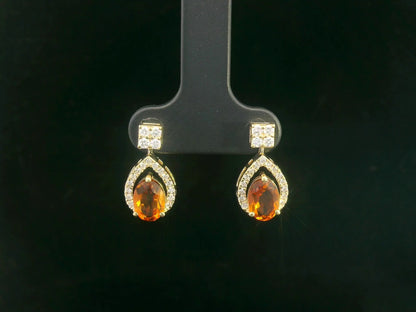 Oval citrine and diamond halo earrings in 18K yellow gold by Emirates Diamonds