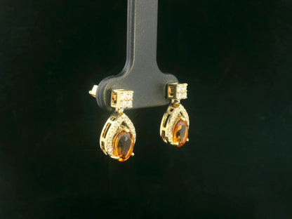 Oval citrine and diamond halo earrings in 18K yellow gold by Emirates Diamonds