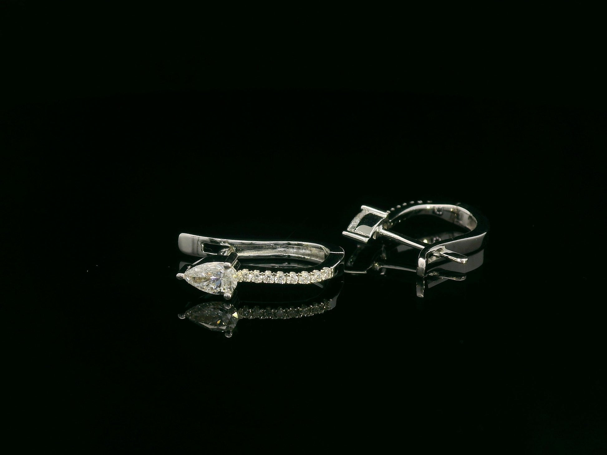 18K white gold hoop earrings with pear-shaped diamonds on top and diamond pavé front by Emirates Diamonds