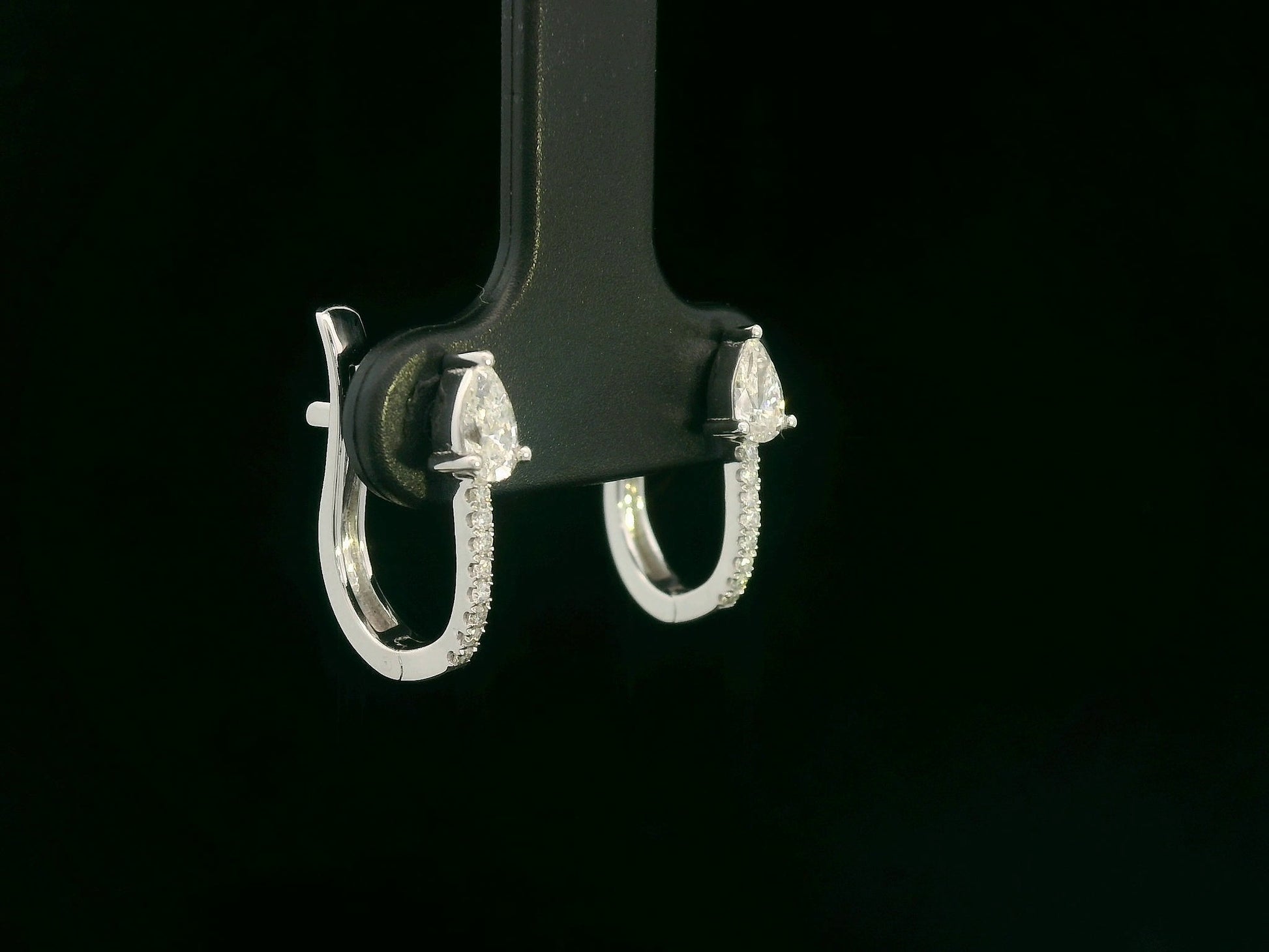 18K white gold hoop earrings with pear-shaped diamonds on top and diamond pavé front by Emirates Diamonds