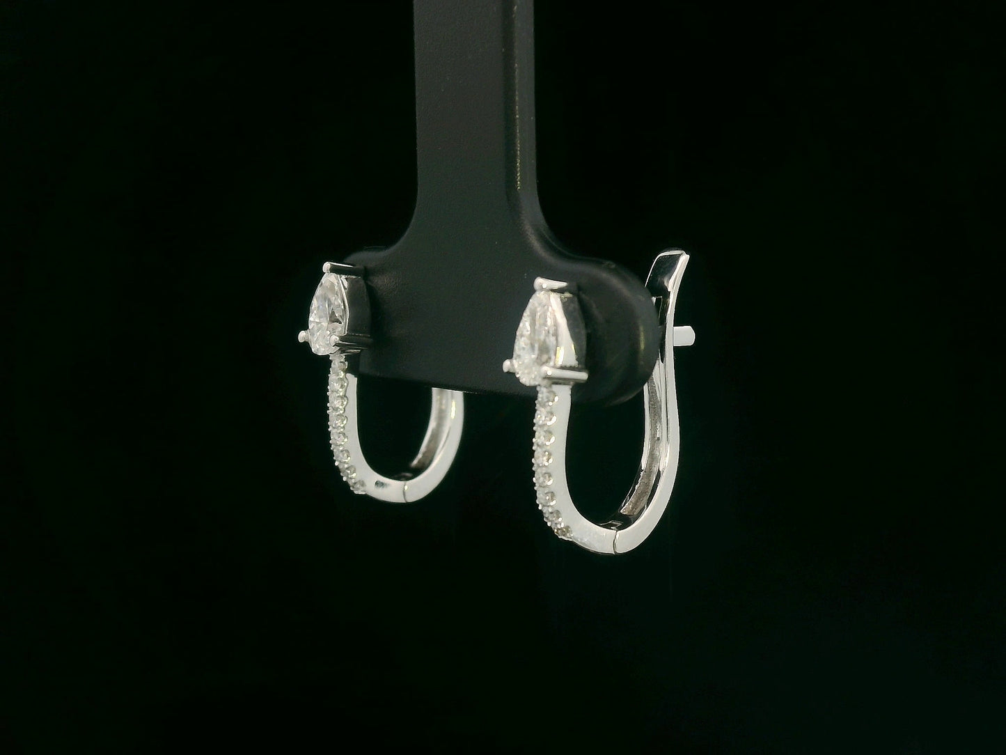 18K white gold hoop earrings with pear-shaped diamonds on top and diamond pavé front by Emirates Diamonds