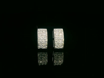 18K white gold pavé diamond bar stud earrings – minimalist curved design with 0.28ct diamonds by Emirates Diamonds.