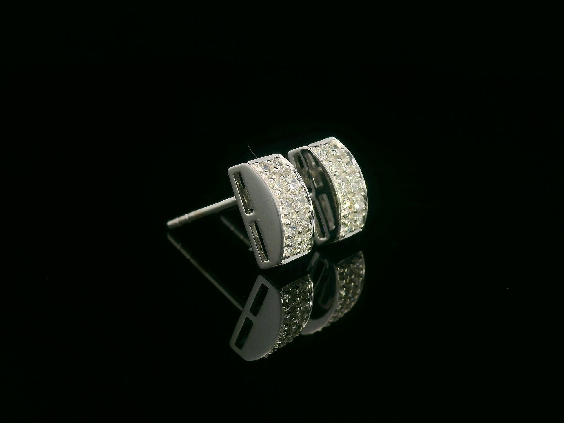 18K white gold pavé diamond bar stud earrings – minimalist curved design with 0.28ct diamonds by Emirates Diamonds.