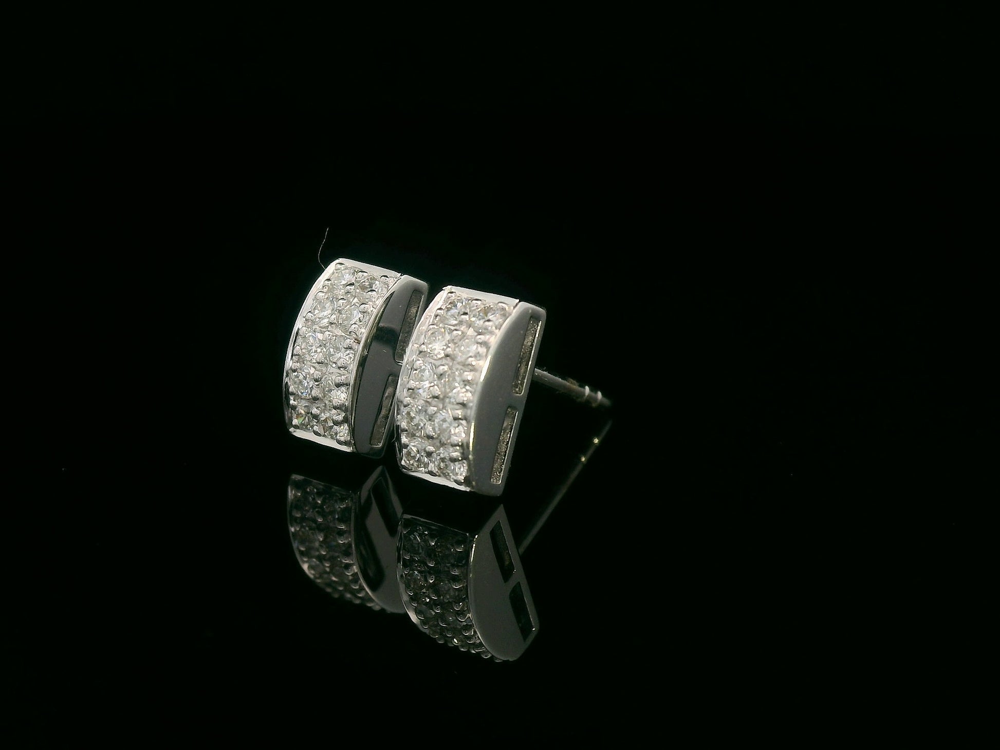 18K white gold pavé diamond bar stud earrings – minimalist curved design with 0.28ct diamonds by Emirates Diamonds.