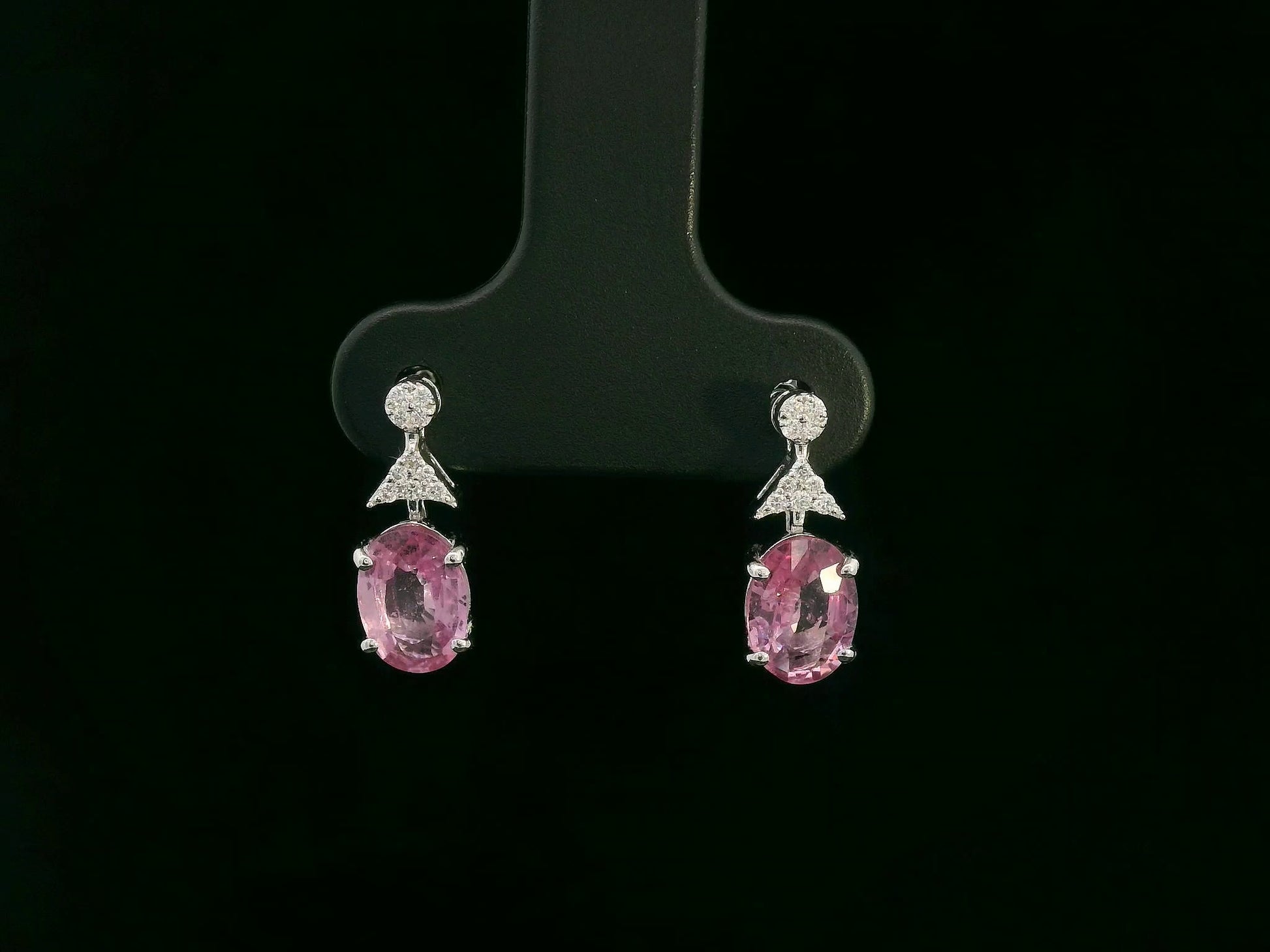 18K white gold pink sapphire and diamond drop earrings – oval pink sapphires with pavé diamond accents, elegant dangling design by Emirates Diamonds.